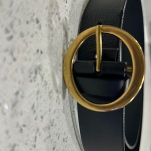 Gold circular buckle leather belt